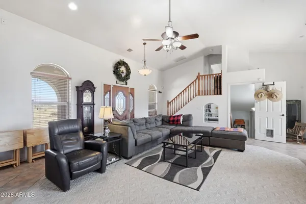a living room with furniture and a floor to ceiling window