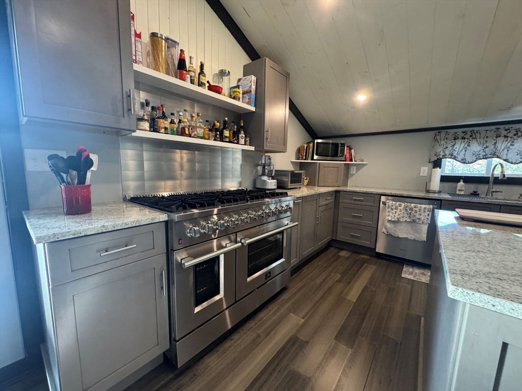 153 Off Pond Street Dunstable, MA 01827 - Photo 10 of 35 a kitchen with stainless steel appliances granite countertop a stove and a sink