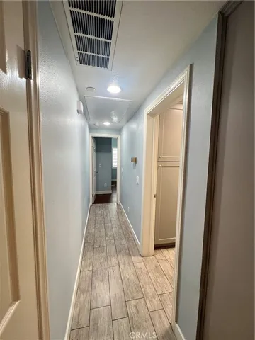 a view of hallway with wooden floor