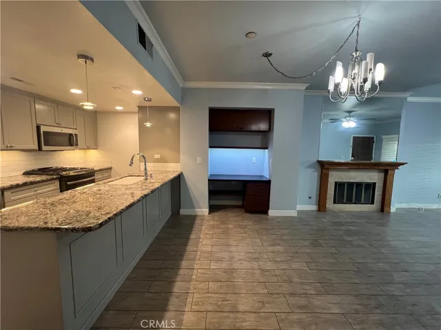 a large kitchen with stainless steel appliances granite countertop a sink and cabinets
