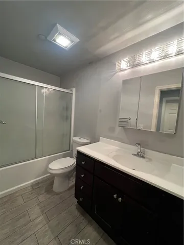 a bathroom with a sink vanity and toilet