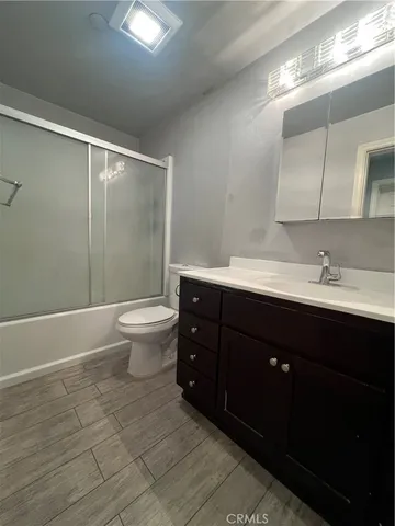 a bathroom with a double vanity sink toilet and shower