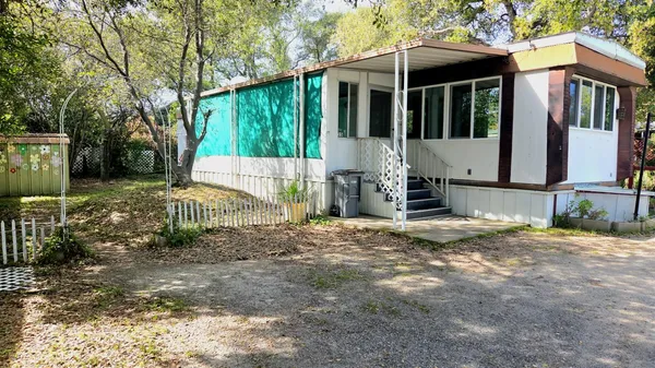a view of a house with backyard and sitting area