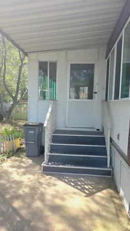 a view of entryway with wooden floor and a front door