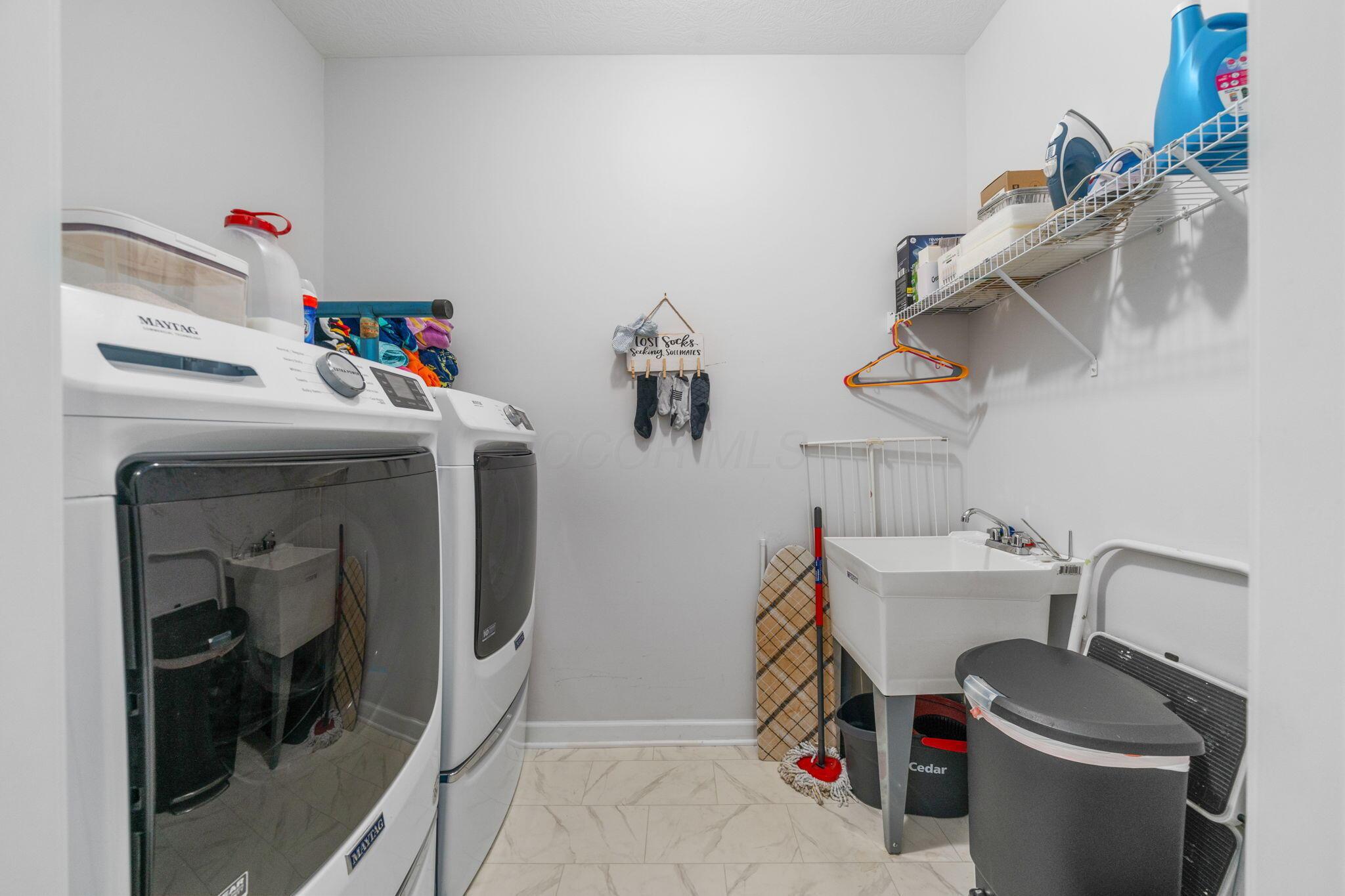 727 Fescue Road Galena, OH 43021 - Photo 45 of 85 The laundry room contains a utility sink and shelving.