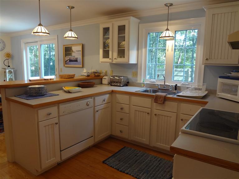 61 Clamshell Cove Road Cotuit, MA 02635 - Photo 8 of 12 a kitchen with sink cabinets and window