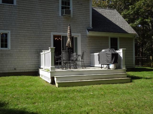 61 Clamshell Cove Road Cotuit, MA 02635 - Photo 9 of 12 a front view of a house with a garden and yard