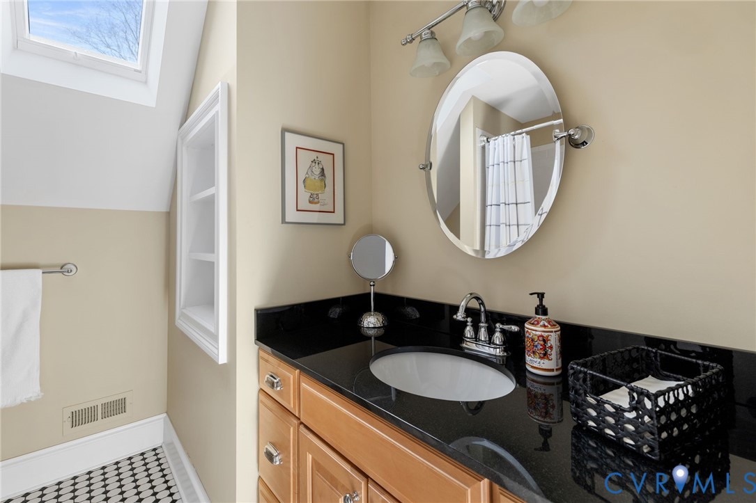 8947 Cherokee Road Richmond, VA 23235 - Photo 31 of 45 a bathroom with a sink and a mirror