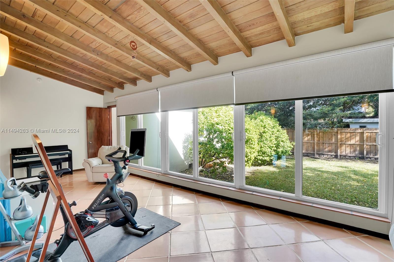 4331 Alton Road Miami Beach, FL 33140 - Photo 12 of 33 a room with gym equipment and large windows
