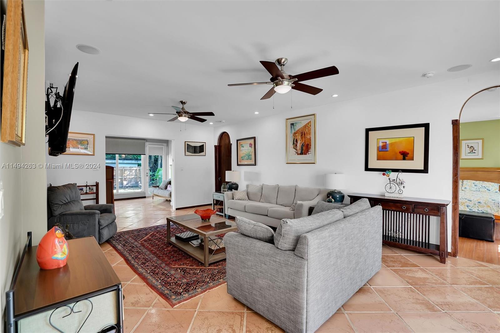 4331 Alton Road Miami Beach, FL 33140 - Photo 15 of 33 a living room with fireplace furniture and a flat screen tv