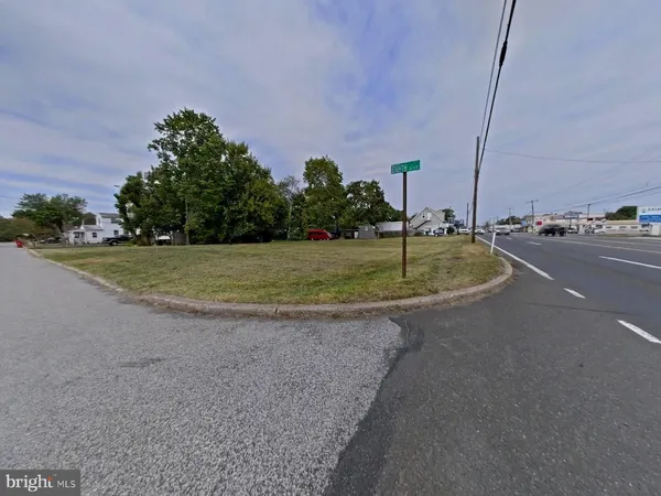 a view of a road with a building in the background