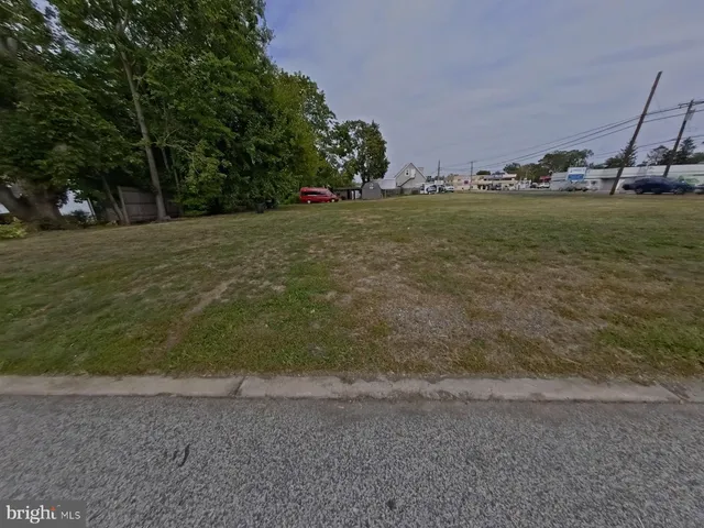 a view of a field with an trees
