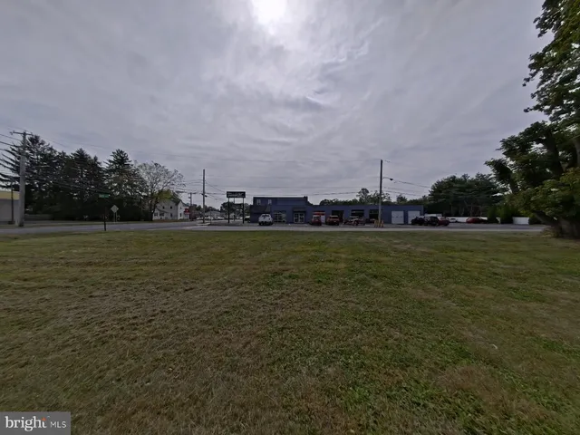 a view of a field with trees in the background