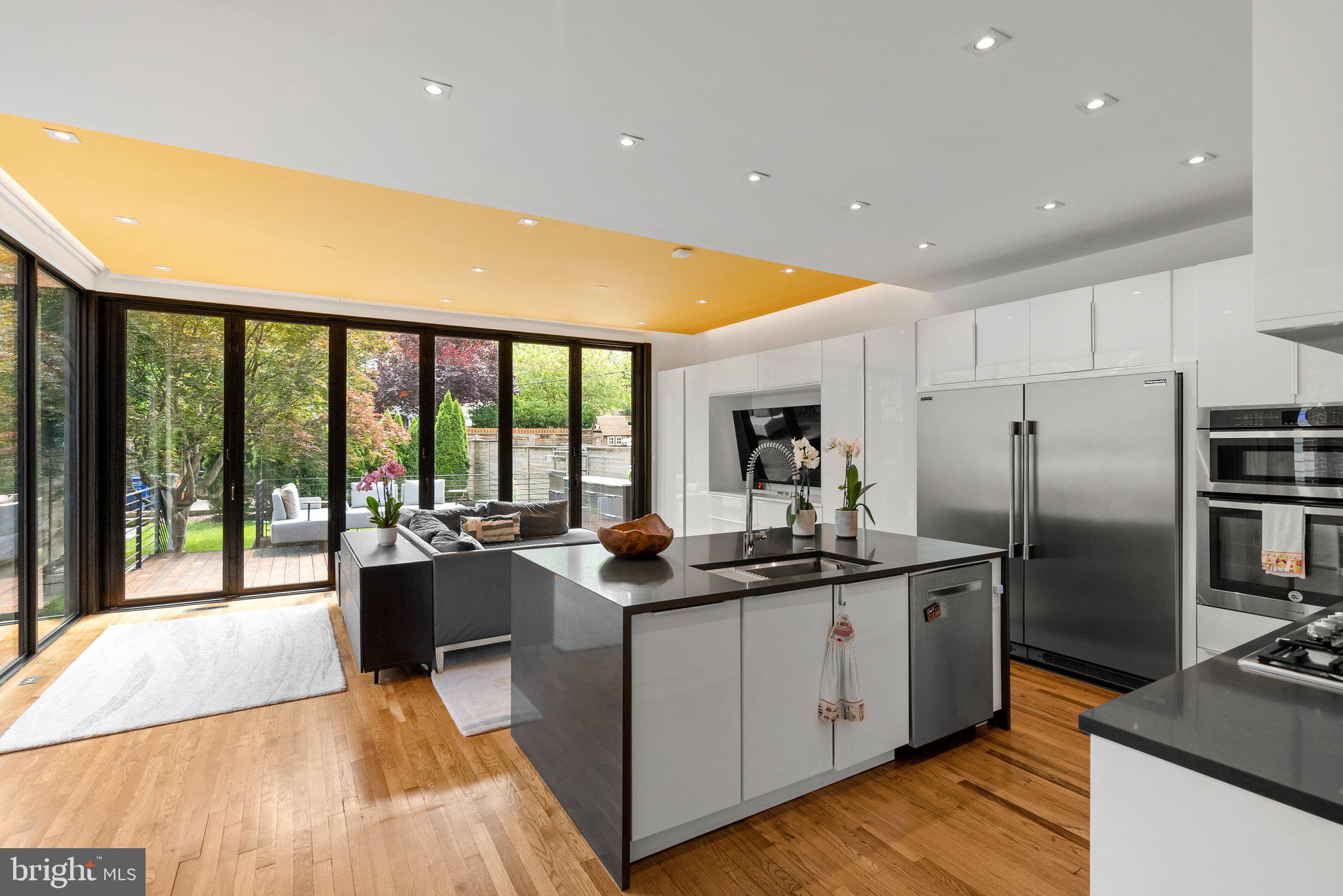 2815 39th Street Northwest Washington, DC 20007 - Photo 11 of 64 a kitchen with stainless steel appliances granite countertop a sink stove and refrigerator