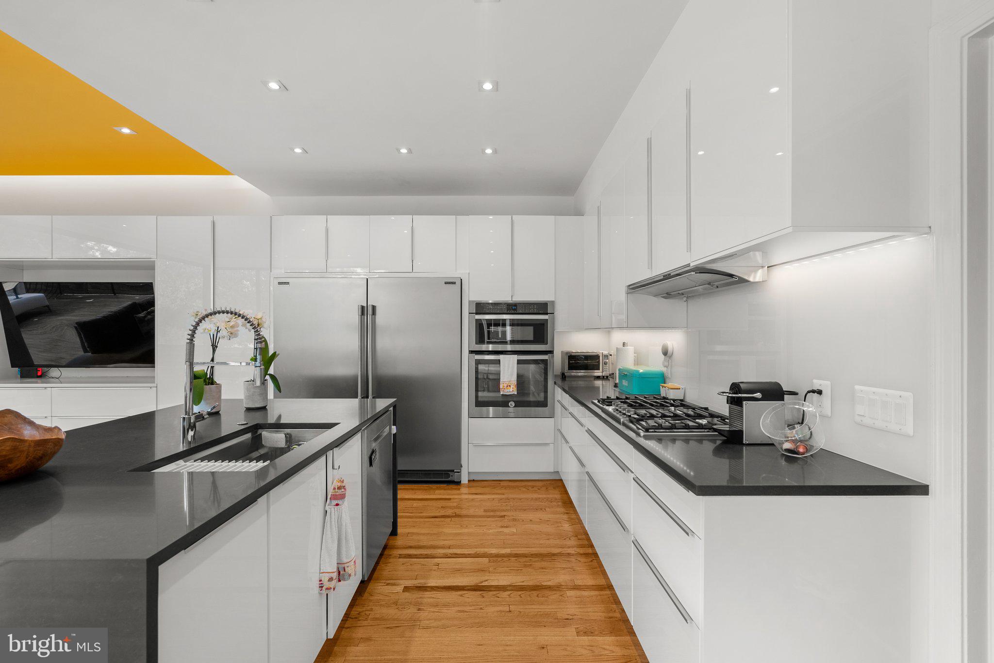 2815 39th Street Northwest Washington, DC 20007 - Photo 14 of 64 a kitchen with granite countertop a sink and stainless steel appliances