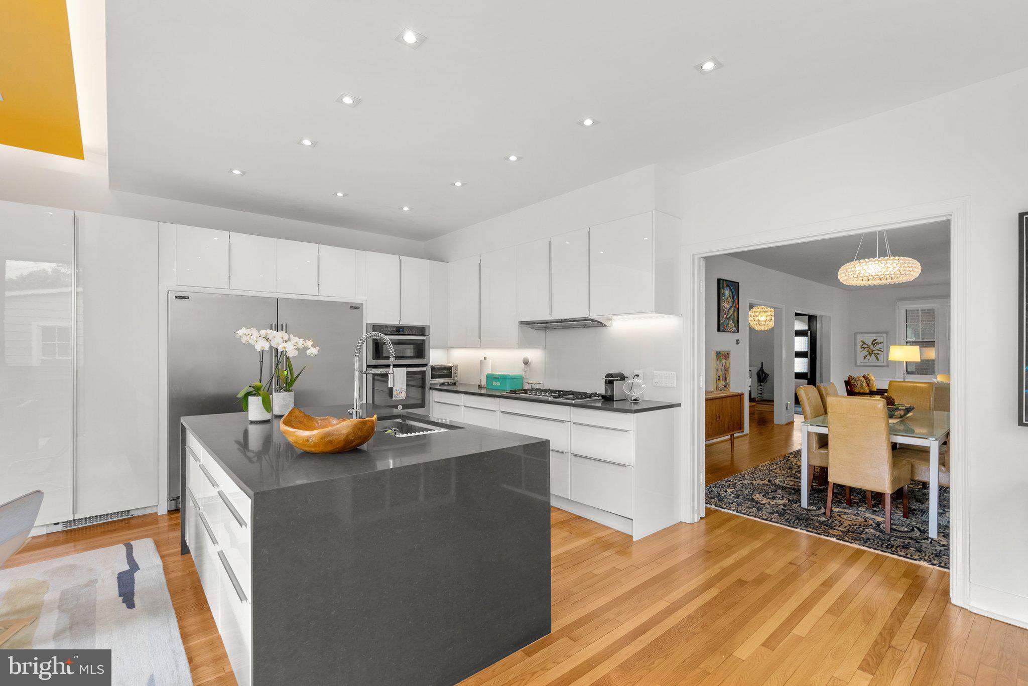 2815 39th Street Northwest Washington, DC 20007 - Photo 15 of 64 a kitchen with a sink a stove and chairs