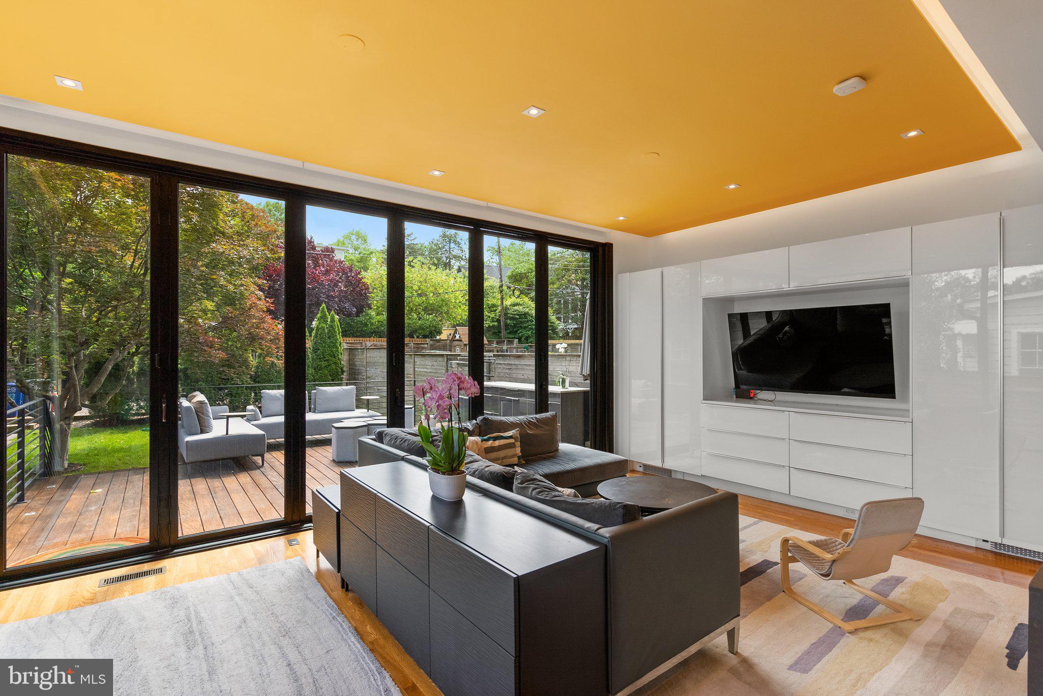 2815 39th Street Northwest Washington, DC 20007 - Photo 19 of 64 a living room with furniture tv and a floor to ceiling window