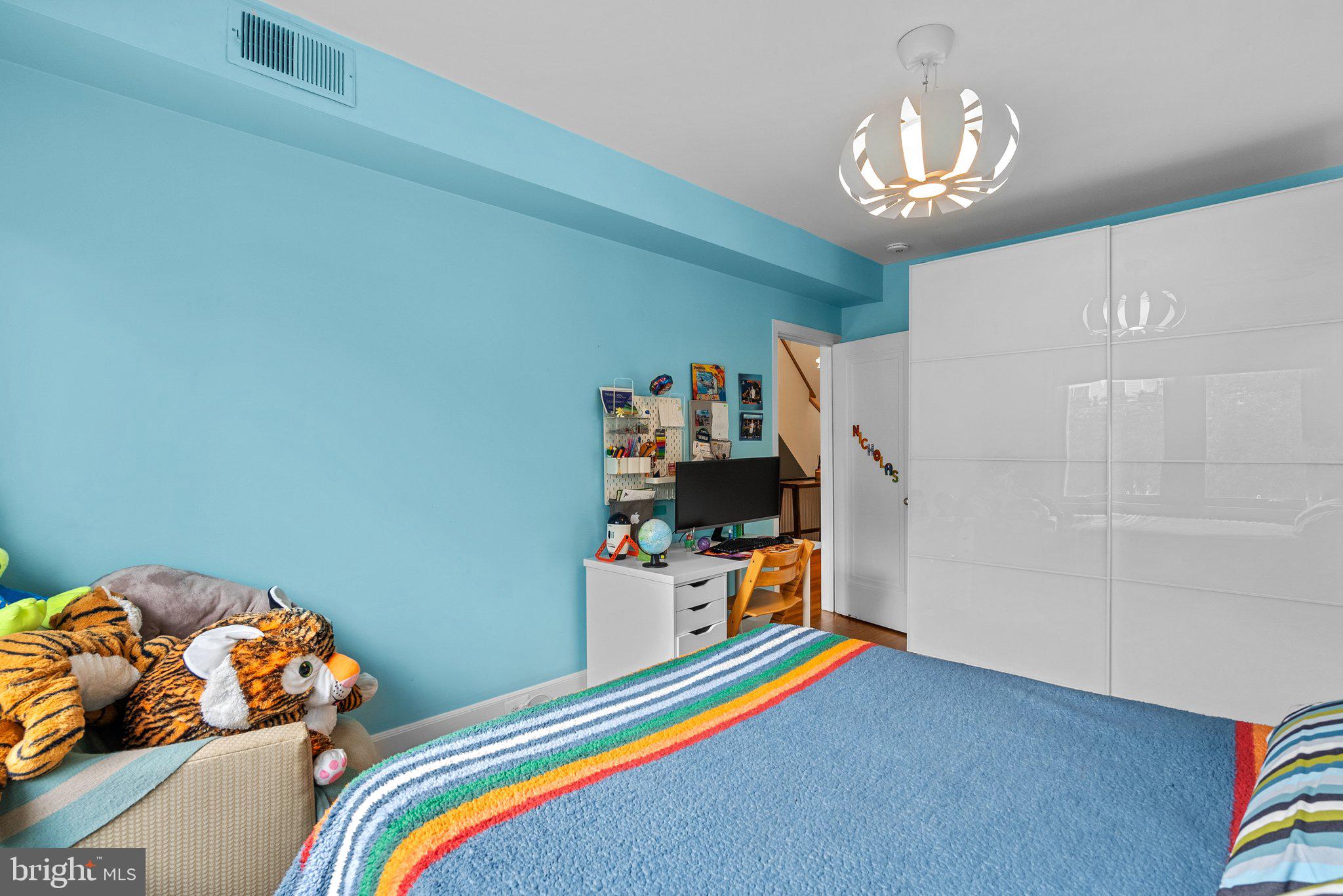 2815 39th Street Northwest Washington, DC 20007 - Photo 32 of 64 a bedroom with a bed and a chandelier