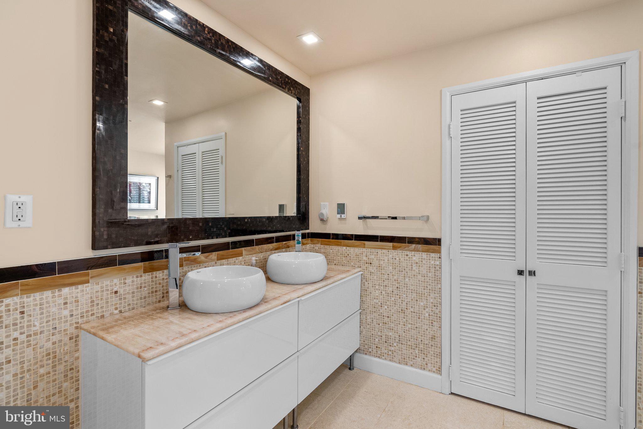 2815 39th Street Northwest Washington, DC 20007 - Photo 41 of 64 a bathroom with a granite countertop sink and a mirror