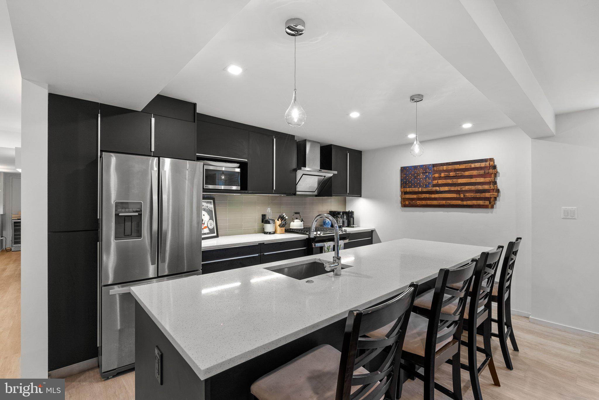 2815 39th Street Northwest Washington, DC 20007 - Photo 48 of 64 a kitchen with a table a refrigerator a dining table and chairs