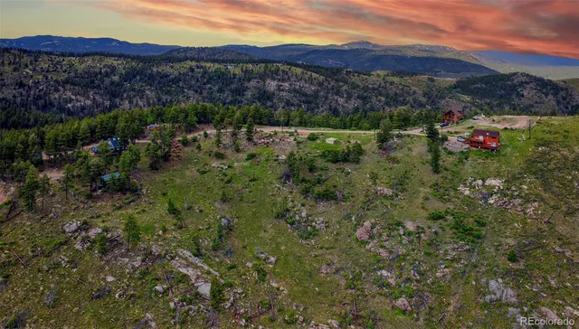 an aerial view of residential house and sandy dunes