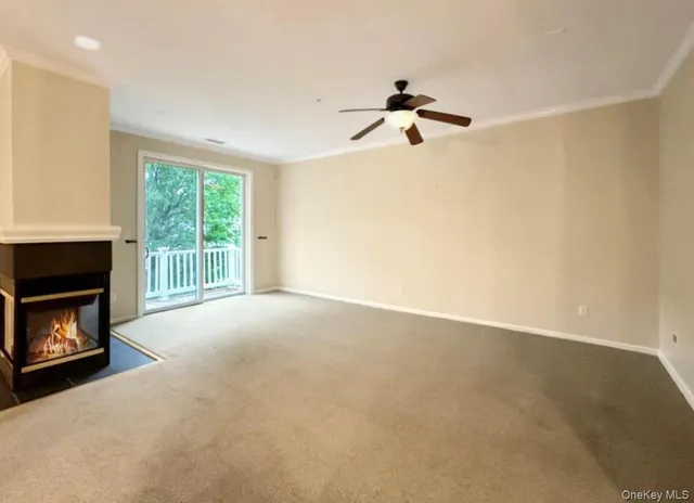 a view of empty room with a fireplace