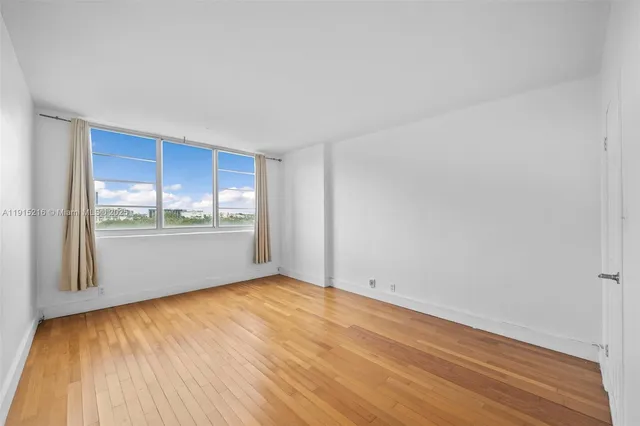 a view of a kitchen with wooden floor and a kitchen