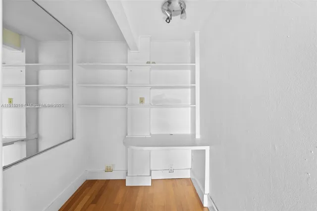 a view of a room with wooden floor