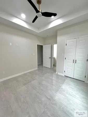 a view of a livingroom with a ceiling fan and window