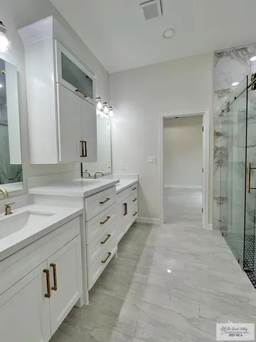 a bathroom with a sink vanity and mirror