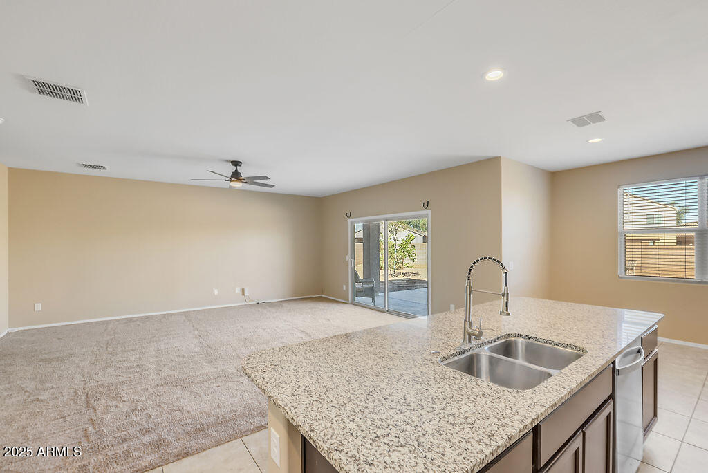 28414 Cinnabar Road San Tan Valley, AZ 85143 - Photo 11 of 32 a kitchen with sink and refrigerator