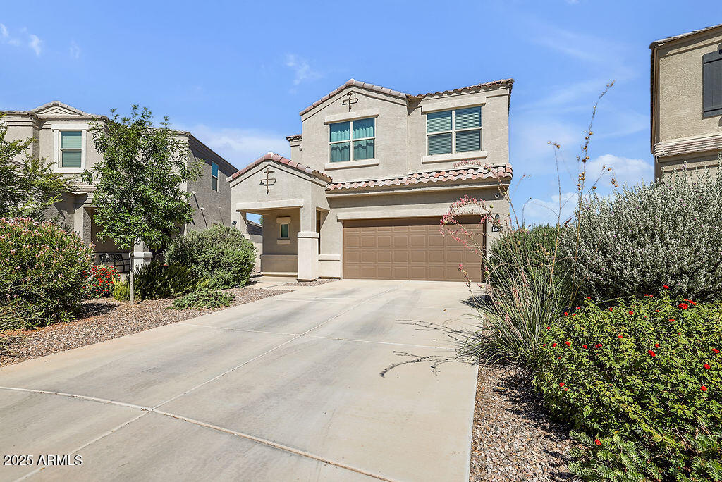 28414 Cinnabar Road San Tan Valley, AZ 85143 - Photo 2 of 32 a front view of a house with a yard and garage