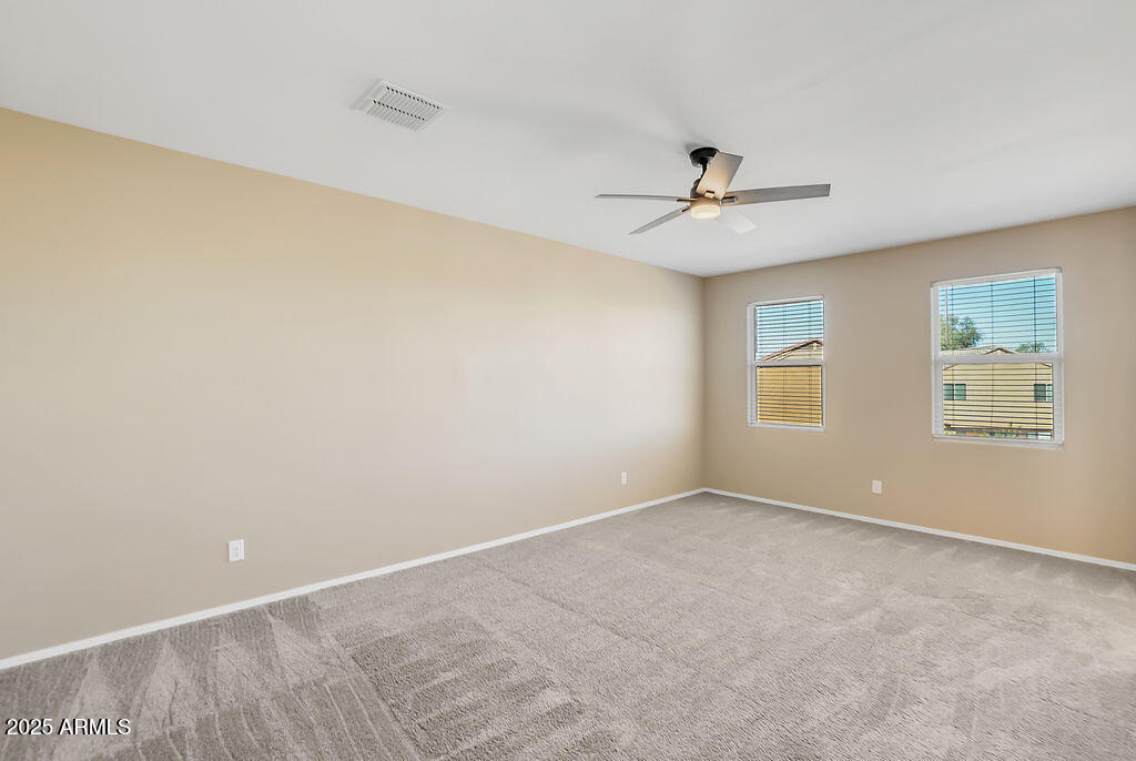 28414 Cinnabar Road San Tan Valley, AZ 85143 - Photo 21 of 32 an empty room with a ceiling fan and a window