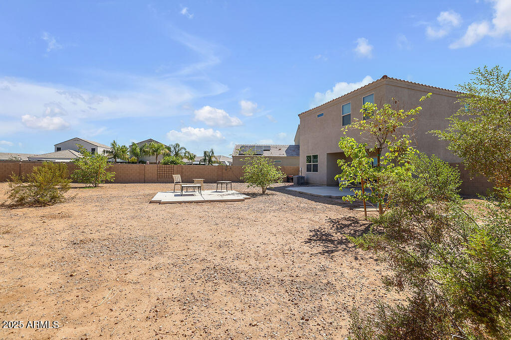 28414 Cinnabar Road San Tan Valley, AZ 85143 - Photo 28 of 32 a view of a yard with an house and wooden fence