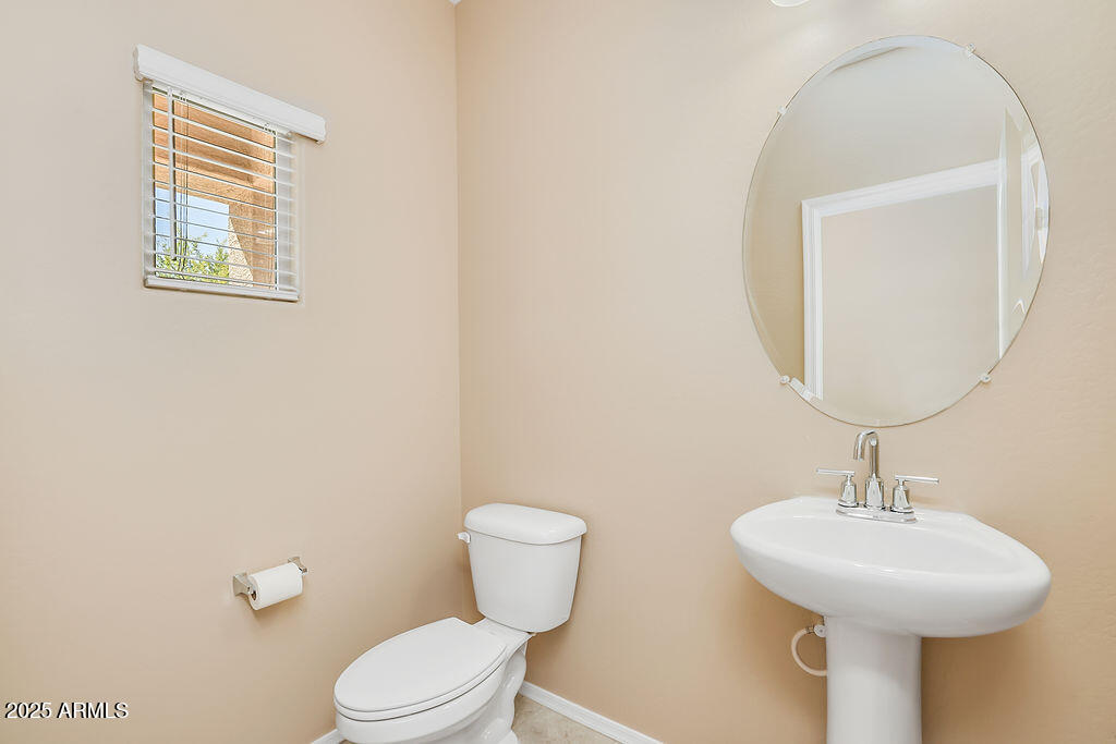 28414 Cinnabar Road San Tan Valley, AZ 85143 - Photo 3 of 32 a bathroom with a toilet sink and mirror