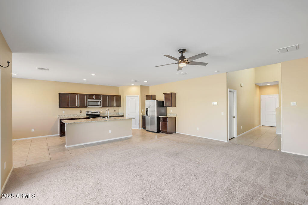 28414 Cinnabar Road San Tan Valley, AZ 85143 - Photo 6 of 32 a view of a kitchen with a sink and a refrigerator