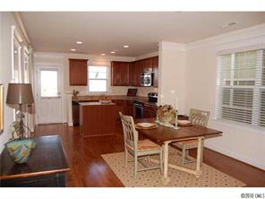 519 Jetton Street Davidson, NC 28036 - Photo 7 of 13 a view of a dining room with furniture and wooden floor