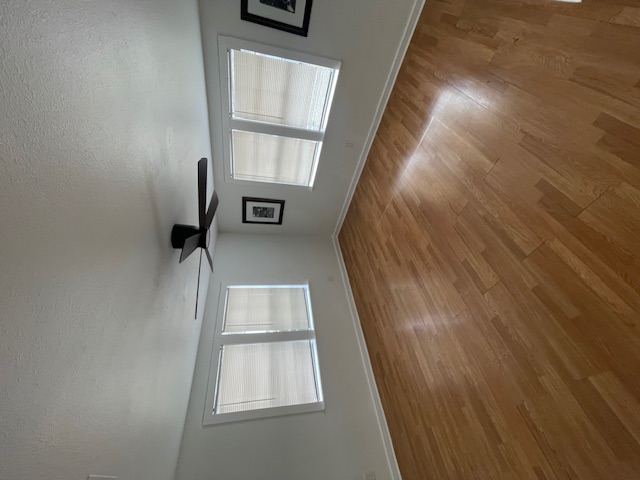 1105 1/2 Tillery Street Austin, TX 78702 - Photo 12 of 19 an empty room with wooden floor and windows