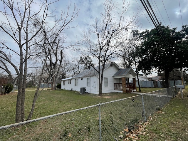 1105 1/2 Tillery Street Austin, TX 78702 - Photo 19 of 19 a view of a white house with a yard covered with snow and trees