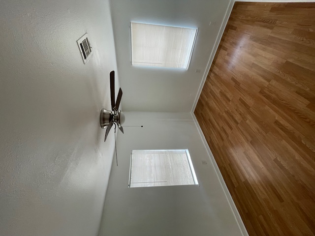 1105 1/2 Tillery Street Austin, TX 78702 - Photo 2 of 19 an empty room with wooden floor air conditioner and windows