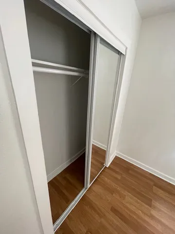 an empty room with wooden floor