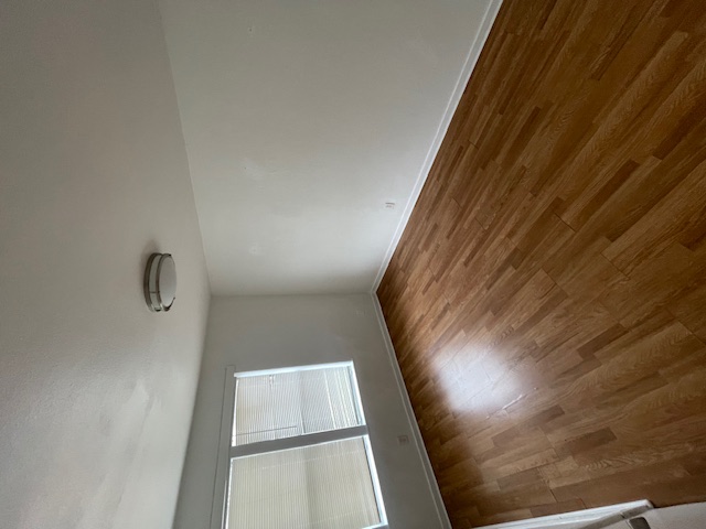 1105 1/2 Tillery Street Austin, TX 78702 - Photo 5 of 19 an empty room with wooden floor and windows