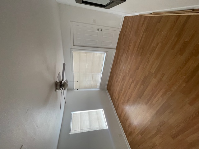 1105 1/2 Tillery Street Austin, TX 78702 - Photo 7 of 19 a view of empty room with wooden floor and fan