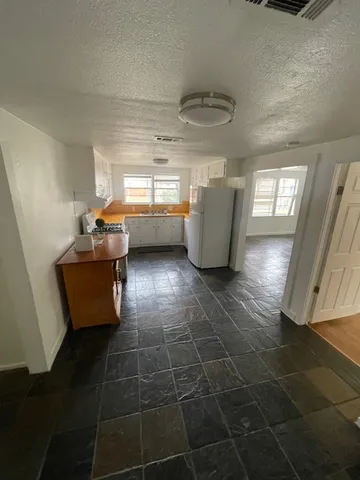 a kitchen with a sink a counter space and cabinets