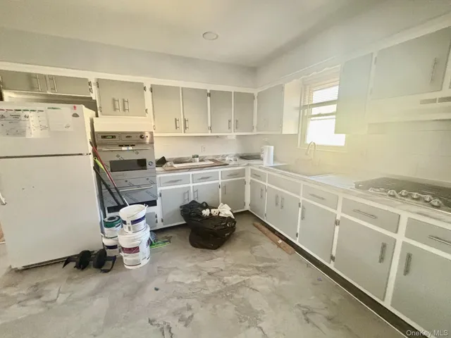 a kitchen with a sink appliances and cabinets
