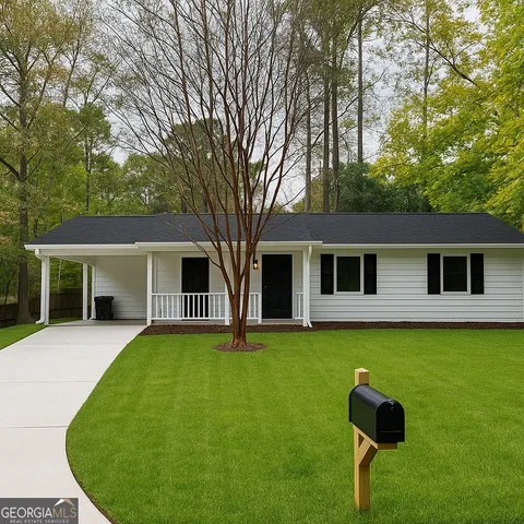 a front view of house with yard and glass windows