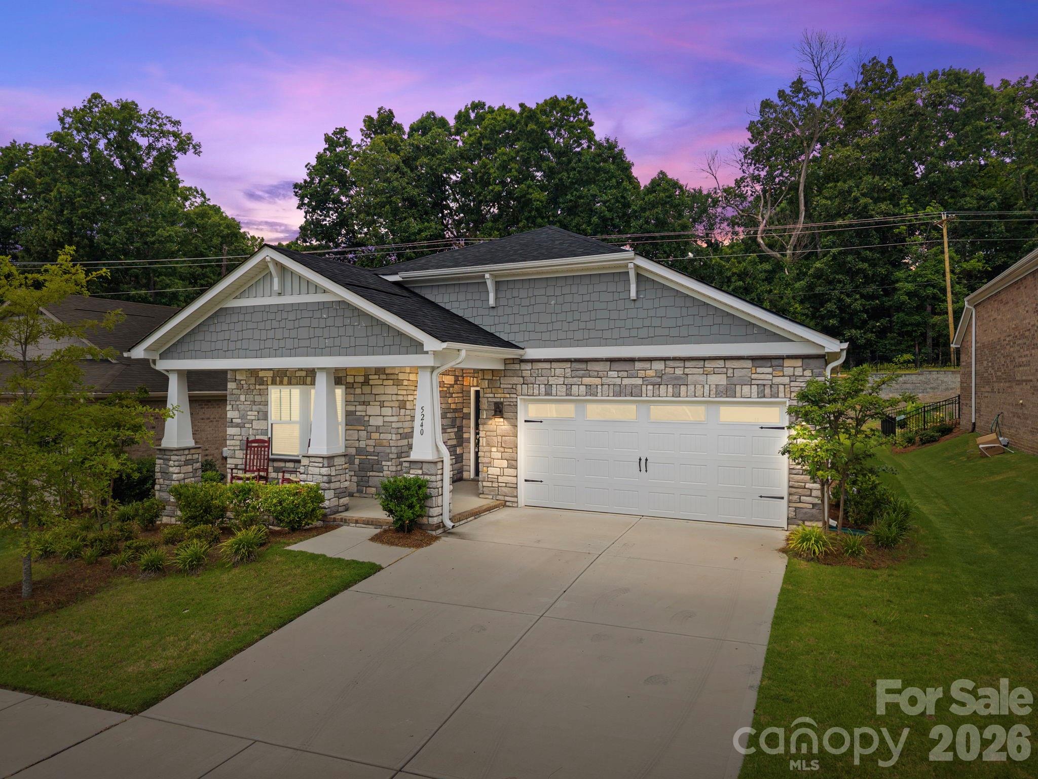 a front view of house with yard and green space