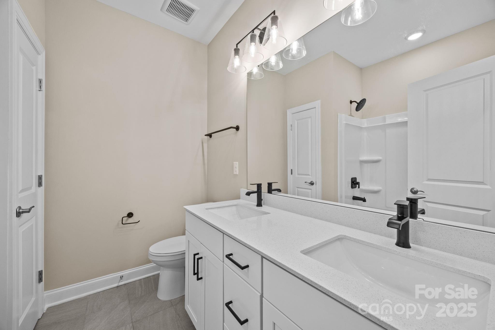 5240 Birchhill Road Mint Hill, NC 28227 - Photo 17 of 48 a bathroom with a sink a toilet and a mirror