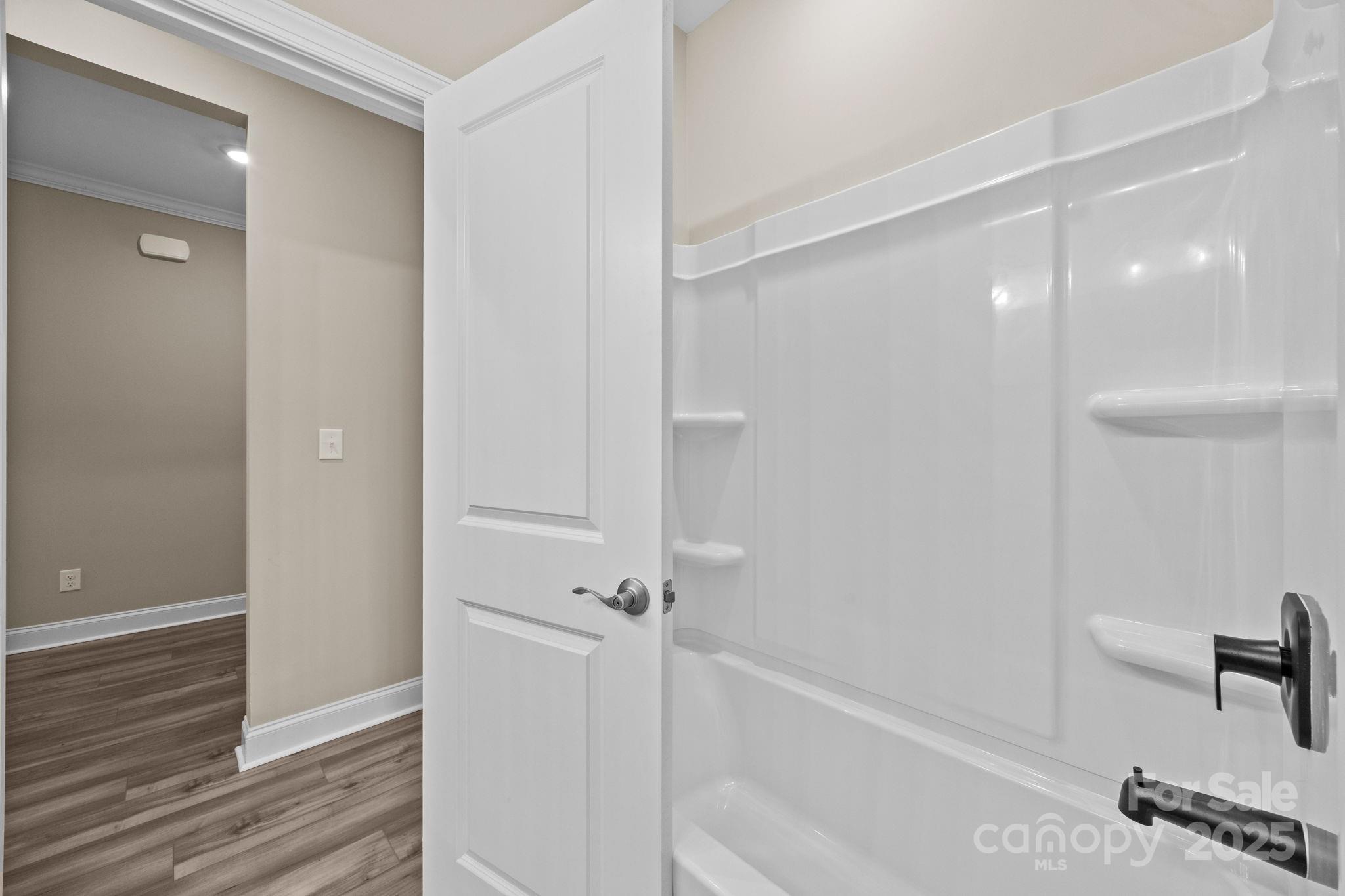 5240 Birchhill Road Mint Hill, NC 28227 - Photo 18 of 48 a bathroom with a bathtub and a shower