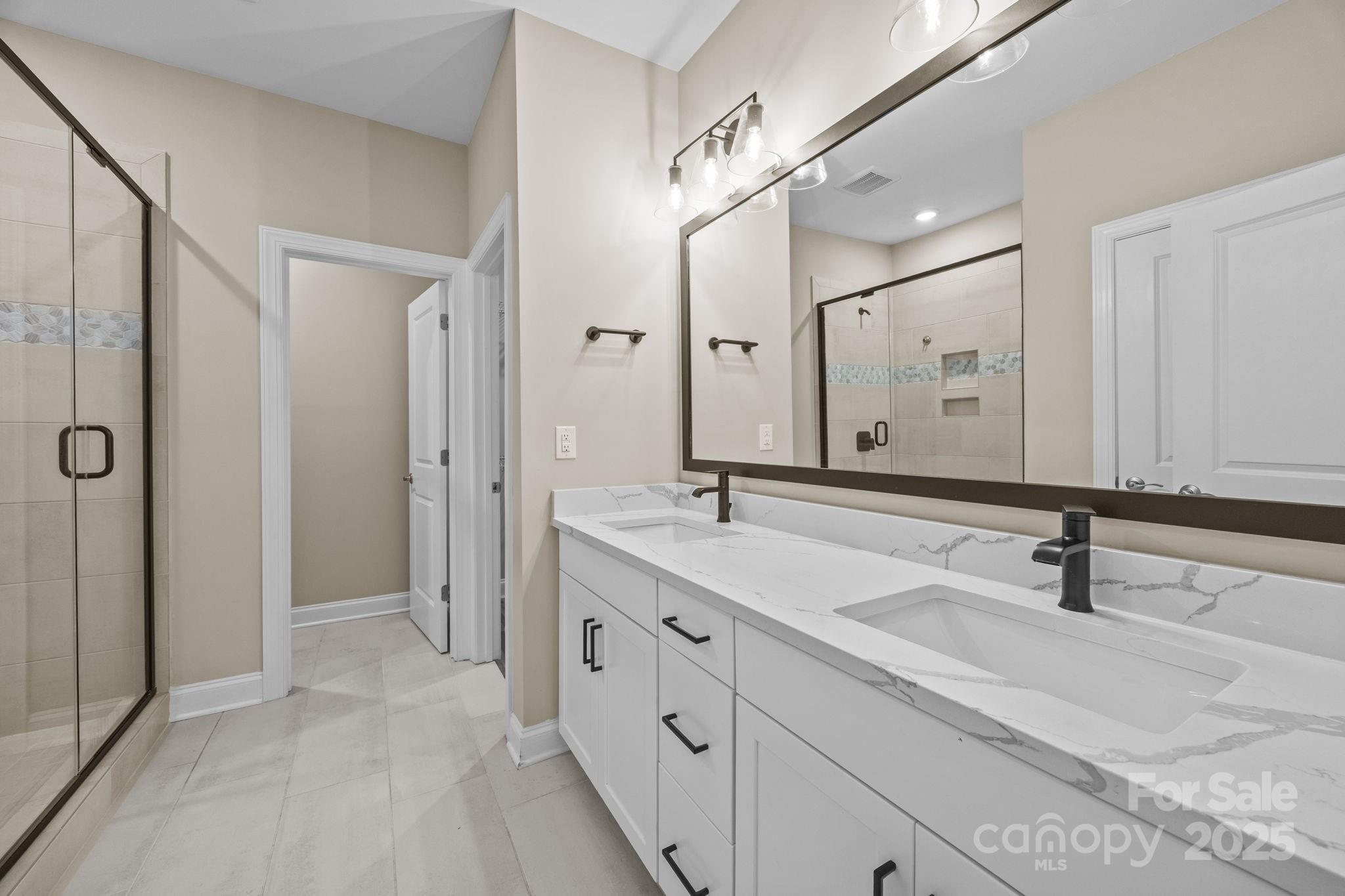 5240 Birchhill Road Mint Hill, NC 28227 - Photo 28 of 48 a bathroom with a double vanity sink mirror and double